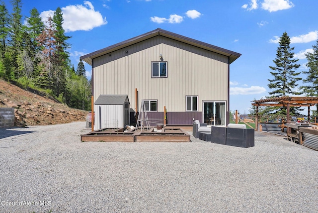 12251 W Blessing Hill Rd, Post Falls, ID 83854 - back of property featuring a shed, a pergola, and an outbuilding
