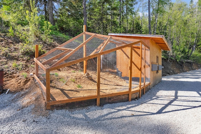 12251 W Blessing Hill Rd, Post Falls, ID 83854 - view of poultry coop featuring a wooded view