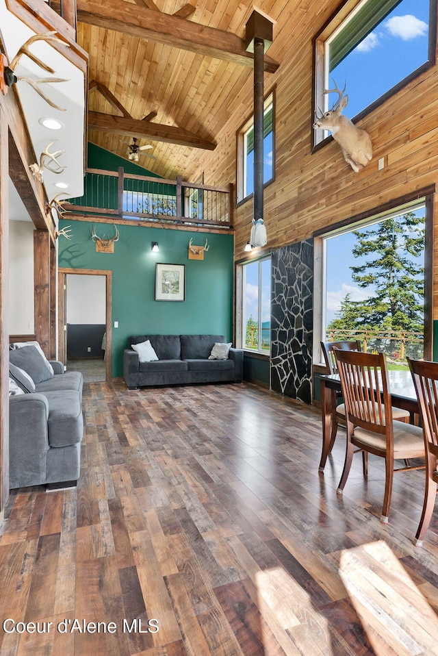 12251 W Blessing Hill Rd, Post Falls, ID 83854 - living area featuring high vaulted ceiling, wood ceiling, beam ceiling, a ceiling fan, and wood-type flooring