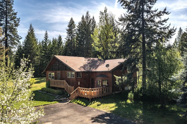 249 Gun Club Rd, Sagle, ID 83860 - chalet / cabin featuring a front yard, a deck, and a wooded view