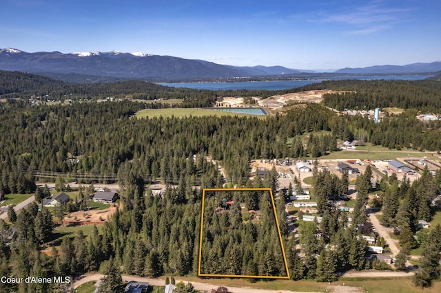 249 Gun Club Rd, Sagle, ID 83860 - aerial view of property and surrounding area with a heavily wooded area, property boundaries highlighted, and a water and mountain view