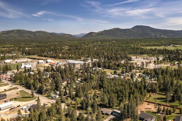 249 Gun Club Rd, Sagle, ID 83860 - aerial overview of property's location featuring a heavily wooded area and a mountainous background