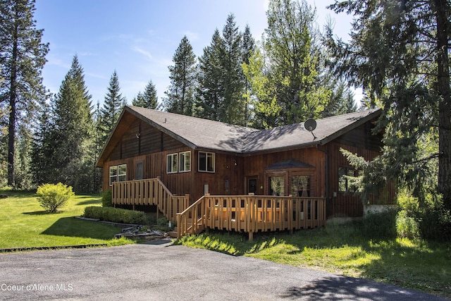 249 Gun Club Rd, Sagle, ID 83860 - view of front of property featuring a wooden deck, a front yard, and a shingled roof