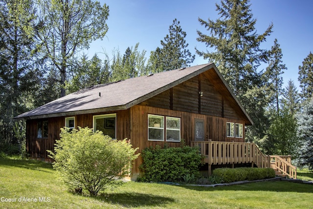 249 Gun Club Rd, Sagle, ID 83860 - view of home's exterior featuring a yard, a wooden deck, and a shingled roof