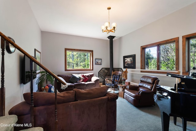 249 Gun Club Rd, Sagle, ID 83860 - living room with carpet flooring, a chandelier, and a wood stove