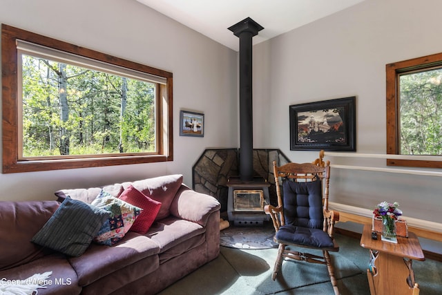 249 Gun Club Rd, Sagle, ID 83860 - living room featuring a wood stove, healthy amount of natural light, and carpet