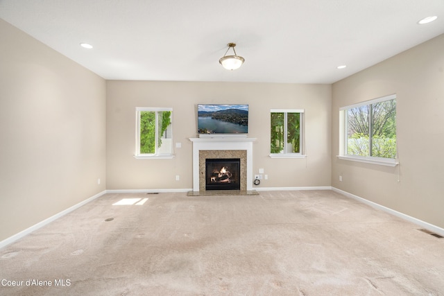 3253 W Magistrate Loop, Hayden, ID 83835 - unfurnished living room featuring light carpet, a fireplace, baseboards, and recessed lighting