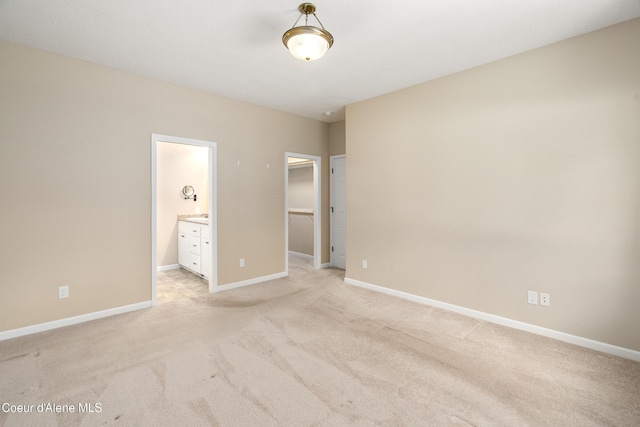 3253 W Magistrate Loop, Hayden, ID 83835 - unfurnished bedroom featuring light carpet, a spacious closet, baseboards, connected bathroom, and a closet