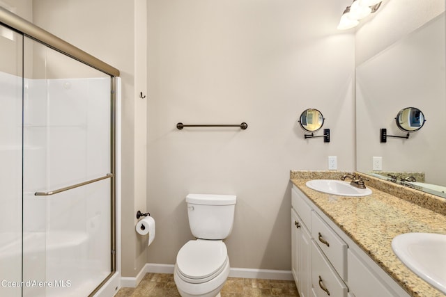 3253 W Magistrate Loop, Hayden, ID 83835 - full bathroom featuring a stall shower, baseboards, double vanity, and toilet