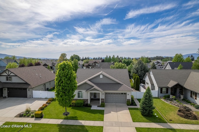 3253 W Magistrate Loop, Hayden, ID 83835 - view of front facade featuring concrete driveway, a residential view, and stone siding