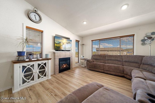 4411 N Campbell Rd, Otis Orchards, WA 99027 - living area featuring vaulted ceiling, wood finished floors, a tile fireplace, baseboards, and recessed lighting