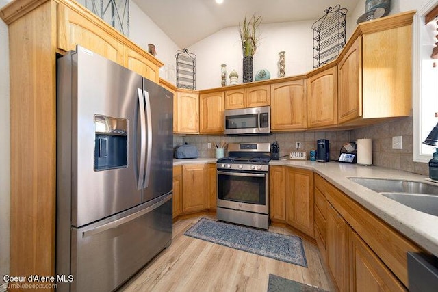 4411 N Campbell Rd, Otis Orchards, WA 99027 - kitchen with appliances with stainless steel finishes, backsplash, light wood-style floors, light countertops, and lofted ceiling