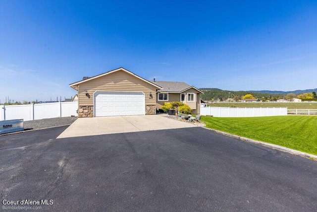 4411 N Campbell Rd, Otis Orchards, WA 99027 - ranch-style house featuring driveway, a garage, and stone siding