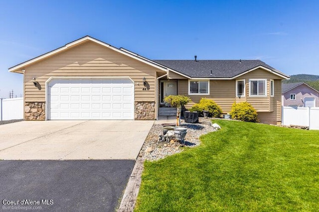 4411 N Campbell Rd, Otis Orchards, WA 99027 - single story home featuring stone siding, concrete driveway, and an attached garage
