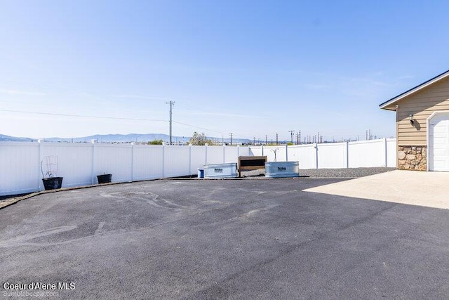 4411 N Campbell Rd, Otis Orchards, WA 99027 - view of vehicle parking featuring fence and a mountain view