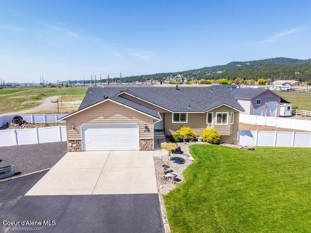 4411 N Campbell Rd, Otis Orchards, WA 99027 - single story home featuring concrete driveway, an attached garage, and stone siding