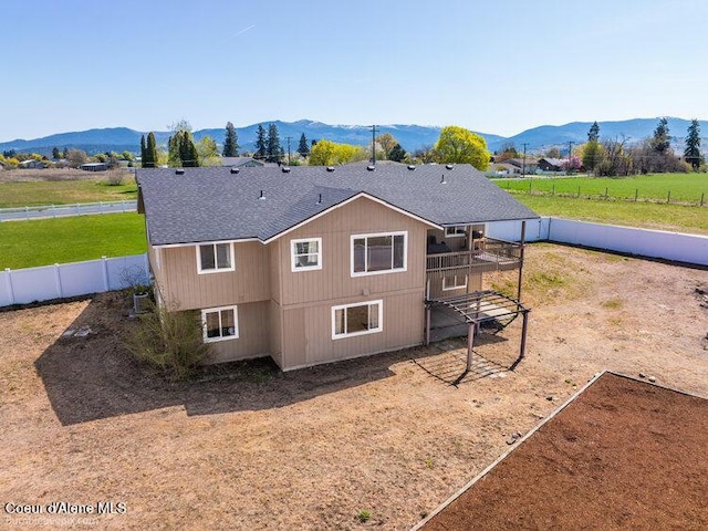 4411 N Campbell Rd, Otis Orchards, WA 99027 - rear view of property with a fenced backyard, a shingled roof, and a deck with mountain view