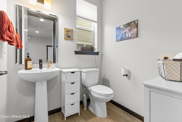 3172 N Cyprus Fox Loop, Post Falls, ID 83854 - half bath with wood finished floors, toilet, and baseboards