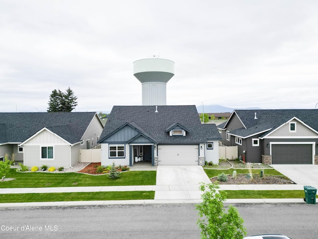 3172 N Cyprus Fox Loop, Post Falls, ID 83854 - view of front facade with driveway, roof with shingles, and board and batten siding