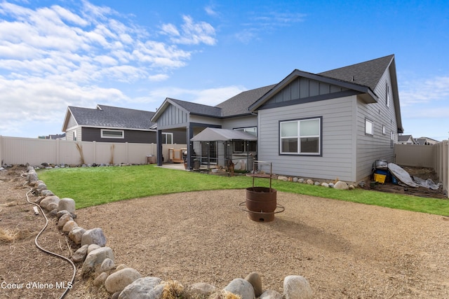 3172 N Cyprus Fox Loop, Post Falls, ID 83854 - rear view of house with board and batten siding, a shingled roof, a patio, and a gazebo