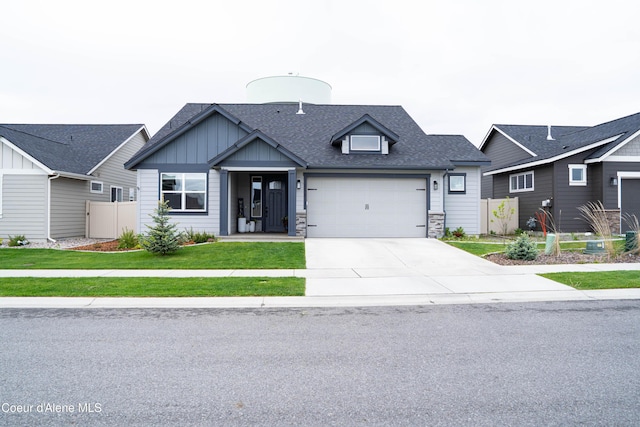 3172 N Cyprus Fox Loop, Post Falls, ID 83854 - view of front facade with a shingled roof, concrete driveway, board and batten siding, and a garage