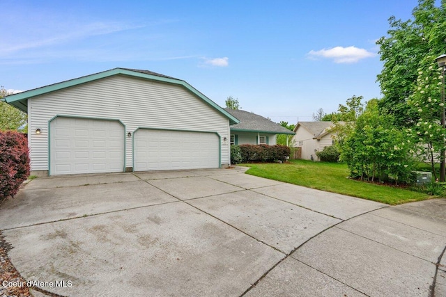 1100 E Autumn Crest Loop, Post Falls, ID 83854 - view of side of home featuring a yard, driveway, and a garage