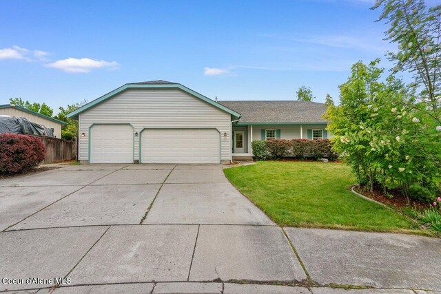 1100 E Autumn Crest Loop, Post Falls, ID 83854 - ranch-style house featuring an attached garage and concrete driveway