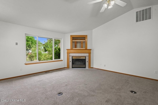 1100 E Autumn Crest Loop, Post Falls, ID 83854 - unfurnished living room with vaulted ceiling, carpet, a tile fireplace, and baseboards
