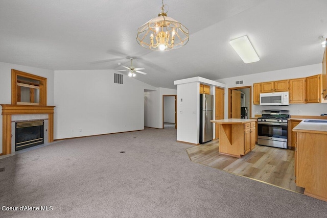 1100 E Autumn Crest Loop, Post Falls, ID 83854 - kitchen with appliances with stainless steel finishes, open floor plan, a sink, lofted ceiling, and light countertops