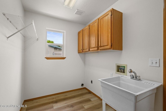 1100 E Autumn Crest Loop, Post Falls, ID 83854 - clothes washing area with washer hookup, light wood-style floors, hookup for an electric dryer, cabinet space, and baseboards