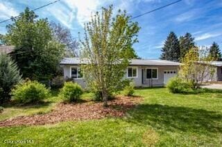 1223 W Superior, Sandpoint, ID 83864 - back of property featuring an attached garage and a yard
