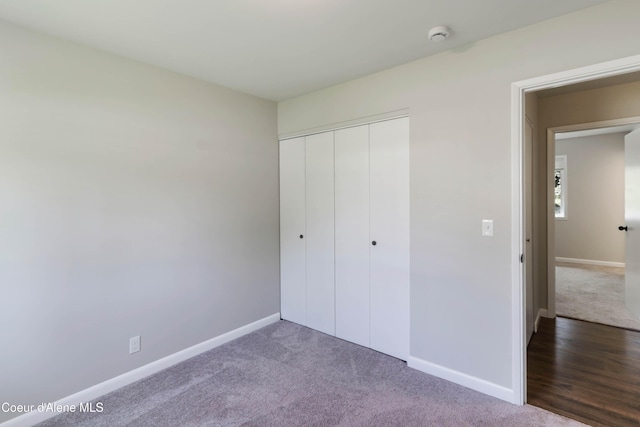 1223 W Superior, Sandpoint, ID 83864 - unfurnished bedroom with baseboards, carpet, and a closet