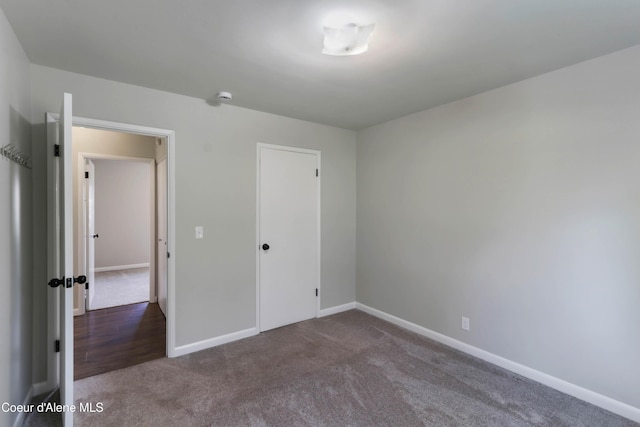 1223 W Superior, Sandpoint, ID 83864 - unfurnished bedroom featuring dark carpet, baseboards, and a closet