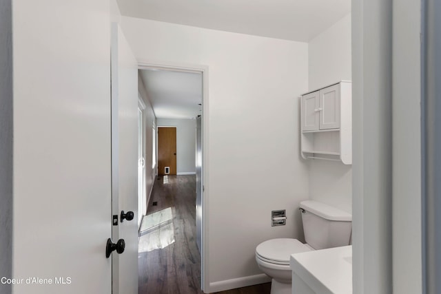 1223 W Superior, Sandpoint, ID 83864 - bathroom with wood finished floors, toilet, baseboards, and vanity
