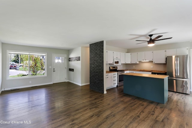 1223 W Superior, Sandpoint, ID 83864 - kitchen featuring appliances with stainless steel finishes, wooden counters, white cabinetry, baseboards, and ceiling fan