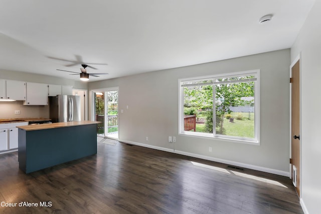 1223 W Superior, Sandpoint, ID 83864 - kitchen featuring freestanding refrigerator, butcher block countertops, baseboards, dark wood finished floors, and white cabinetry