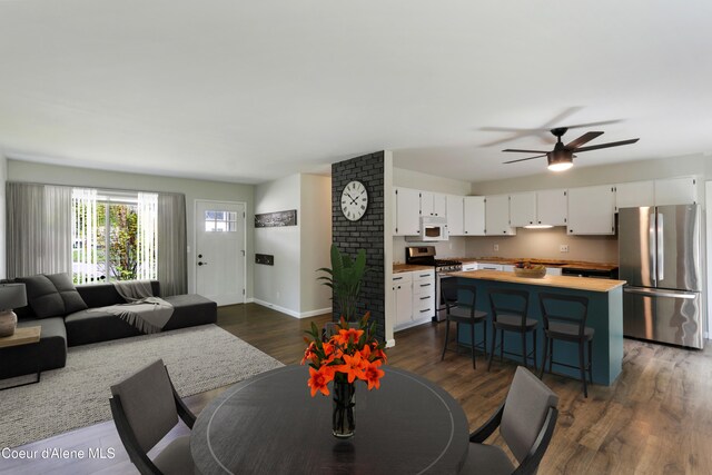 1223 W Superior, Sandpoint, ID 83864 - dining area with dark wood finished floors, baseboards, and a ceiling fan