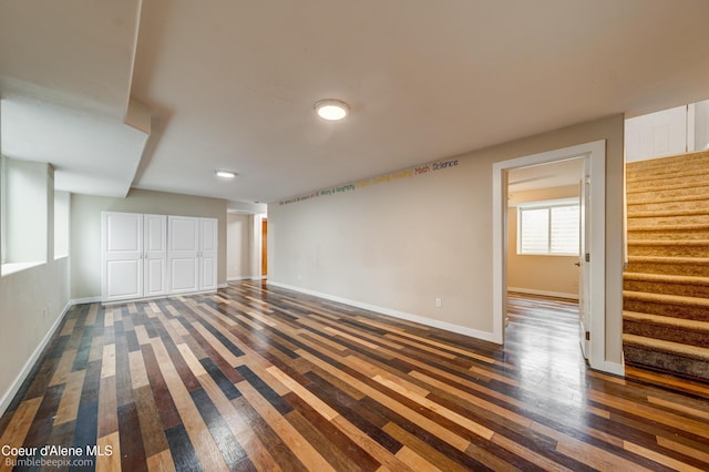 30603 N Riffle Rd, Spirit Lake, ID 83869 - below grade area with stairway, dark wood-style flooring, and baseboards