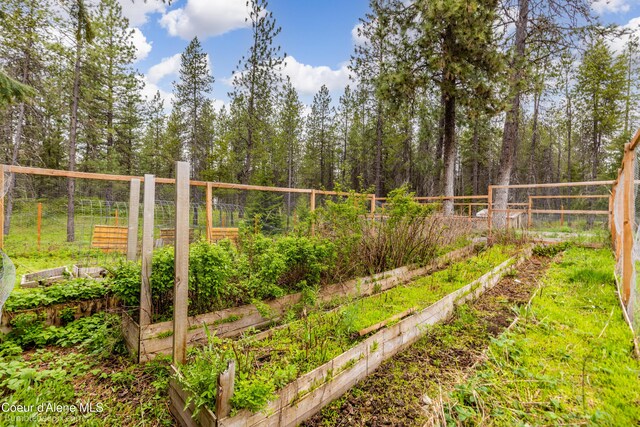 30603 N Riffle Rd, Spirit Lake, ID 83869 - view of yard with a vegetable garden and fence