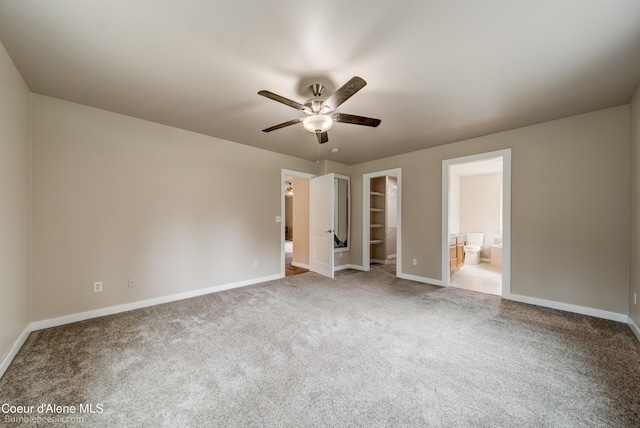 30603 N Riffle Rd, Spirit Lake, ID 83869 - unfurnished bedroom with a walk in closet, carpet flooring, and baseboards