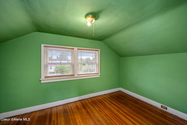 bonus room featuring baseboards, vaulted ceiling, and wood finished floors