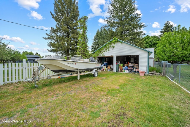 view of yard featuring a detached garage and an outbuilding