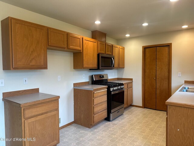 1205 Kinnikinnik Ave, Sandpoint, ID 83864 - kitchen with stainless steel appliances, recessed lighting, and brown cabinetry