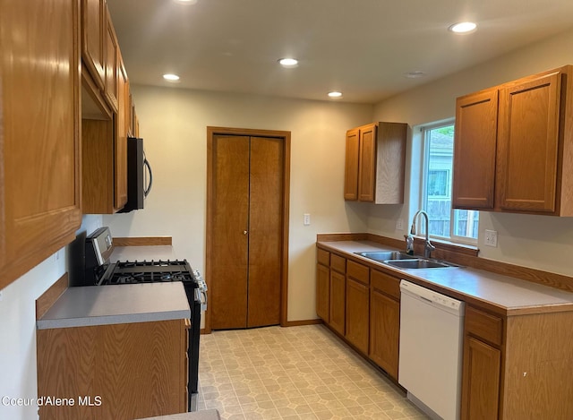 1205 Kinnikinnik Ave, Sandpoint, ID 83864 - kitchen featuring dishwasher, gas range, recessed lighting, brown cabinets, and light countertops