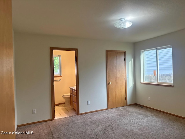 1205 Kinnikinnik Ave, Sandpoint, ID 83864 - unfurnished bedroom with light carpet and ensuite bath