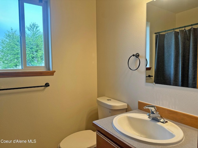 1205 Kinnikinnik Ave, Sandpoint, ID 83864 - bathroom with vanity, a textured wall, and a shower with curtain