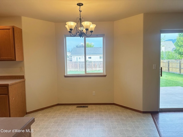 1205 Kinnikinnik Ave, Sandpoint, ID 83864 - unfurnished dining area featuring plenty of natural light and a chandelier