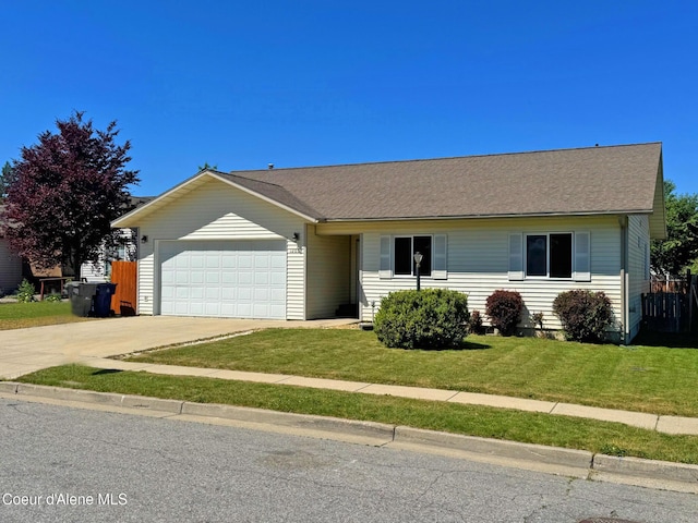 1205 Kinnikinnik Ave, Sandpoint, ID 83864 - single story home with a garage, driveway, and a front lawn