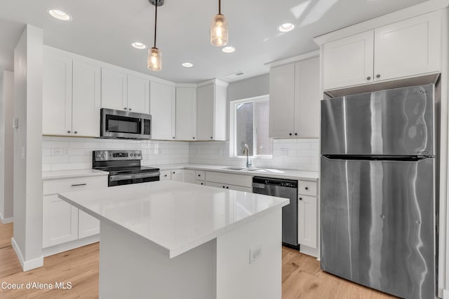 161 White Way, Priest River, ID 83856 - kitchen with stainless steel appliances, a sink, a center island, light wood-type flooring, and recessed lighting