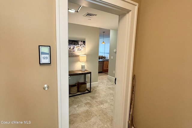 corridor featuring baseboards